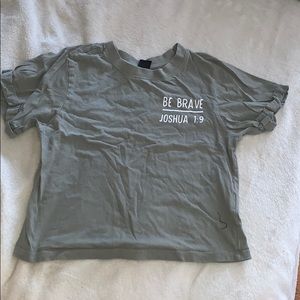 greenish colored tee with words on back